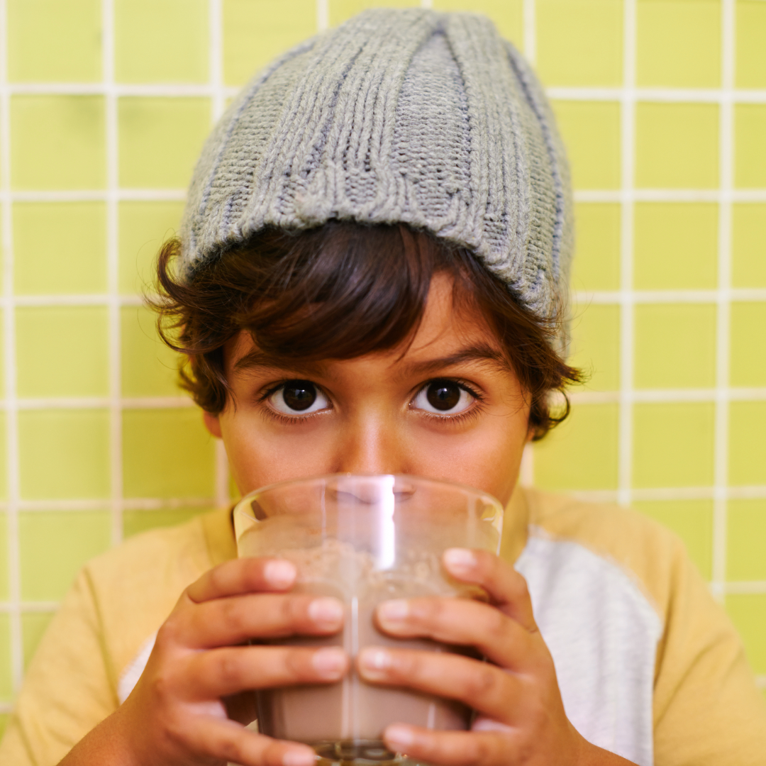 Young Boy with brown eyes drinking FodMap foods Shake